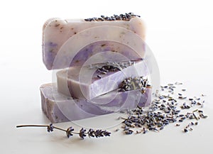 Bars of lavender soap with dried buds scattered around