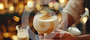 Bartender artfully decorates cocktail with copy space on blurred background