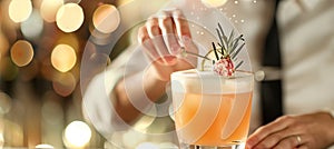 Bartender artfully decorates cocktail with copy space on blurred background