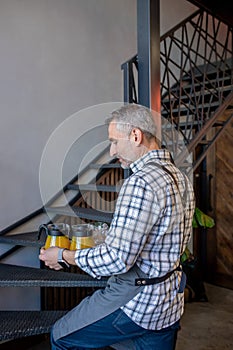 Bartender carrying citrus beverages to his customers