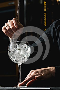 Bartender cooling out Cocktail glass