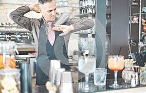 Bartender doing flair inside american cocktail bar - Barman at work performing freestyle show - Focus on man hand shaker - Work,