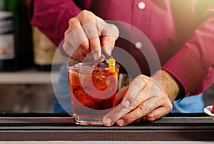 Bartender garnishing a cocktail at the bar