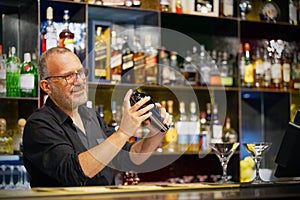 Male bartender makes a cocktail