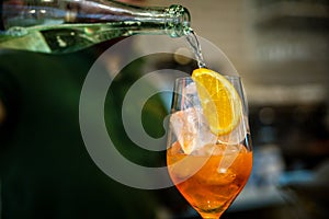 The bartender makes a cocktail. Pouring alcohol from a bottle