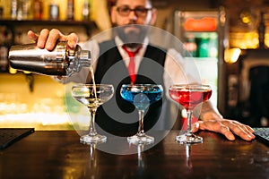 Bartender making alcohol beverages in nightclub