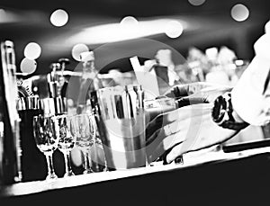 Bartender making alcohol cocktail at bar counter at nightclub, barman is making cocktail