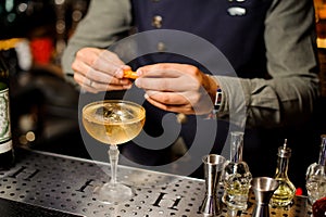 Bartender making an alcoholic cocktail on the bar counter