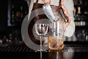 Bartender making cocktail at bar counter