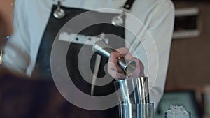 Bartender is making cocktail at bar counter at night club