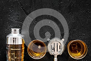 Bartender making cocktail with whiskey the bar counter black background top view copyspace