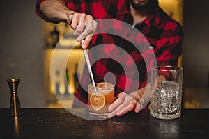 Bartender making and decorating cocktail close-up