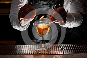 Bartender making fresh alcoholic drink with smoky note