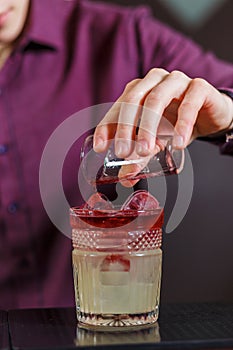 The bartender making New York sour cocktail