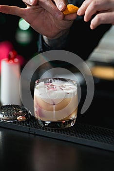 Bartender making relaxing cocktail on a bar background