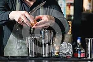 Bartender making relaxing coctail on a bar background
