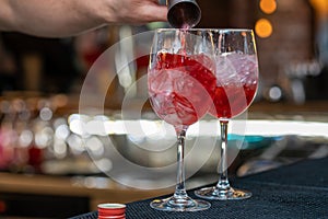 Bartender making relaxing coctail on a bar background