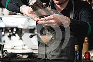 Bartender making relaxing coctail on a bar background