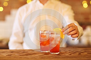 Bartender making two cocktails