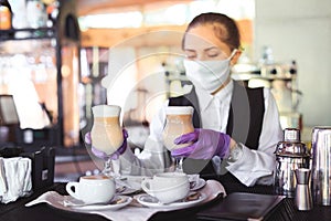 Bartender in medical mask and gloves makes latte coffee