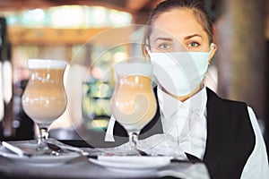 Bartender in medical mask and gloves makes latte coffee