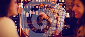 Bartender mixing a cocktail drink in cocktail shaker