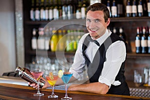 Bartender mixing a cocktail drink in cocktail shaker