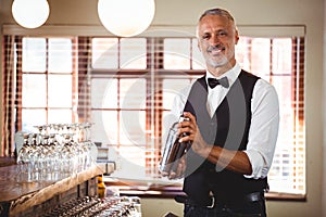 Bartender mixing a cocktail drink in cocktail shaker