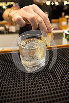 Bartender mixing cocktails for customers on bar counter