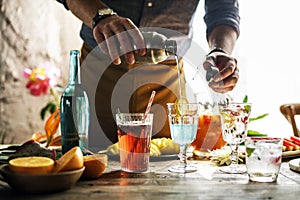 Bartender mixing colorful cocktails