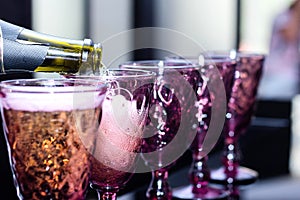 Bartender pouring champagne into glass