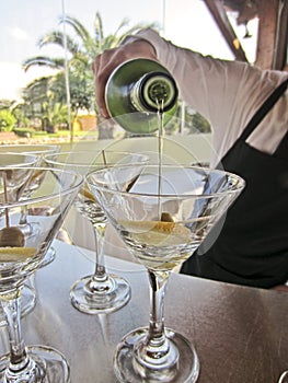 Bartender pouring cocktail martini