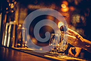 Bartender pouring whisky in a glass