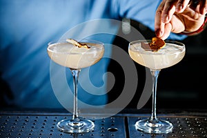 The bartender prepares a cocktail on the bar