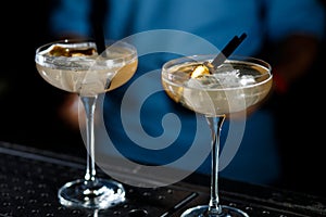 The bartender prepares a cocktail on the bar