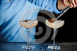 The bartender prepares a cocktail on the bar