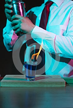 Bartender preparing drink with shaker