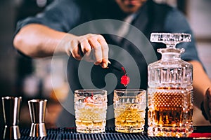 bartender preparing and lining crystal whiskey glasses for alcoholic drinks