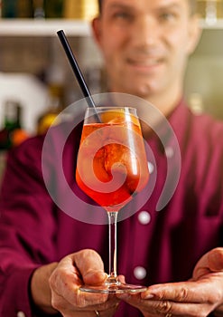 Bartender presenting aperol spritz cocktail photo