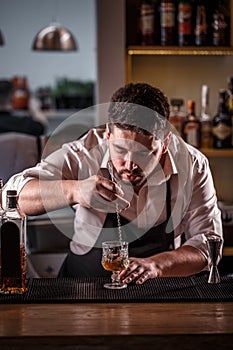 Bartender is stirring cocktail