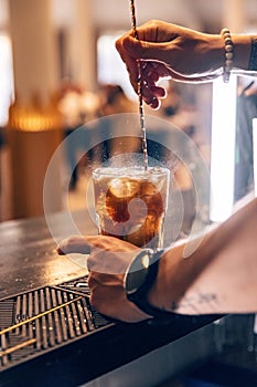 Bartender is stirring cocktail