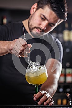 Bartender is stirring cocktail