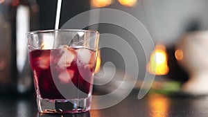 Bartender stirring cocktail spoon cocktail close up