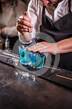 Bartender is stirring cocktails