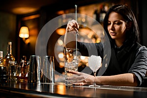 Bartender stirring ice with a bar spoon