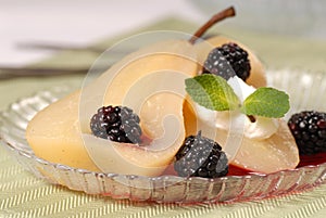 Bartlett pear poached in wine with blackberries photo