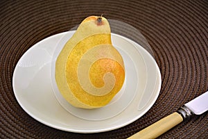 Bartlett pear on white plate