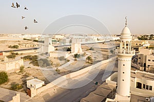 Barzan old watchtowers and a modern mosque. Old Ancient Arabian fortification, Qatar. Middle East. Persian Gulf.