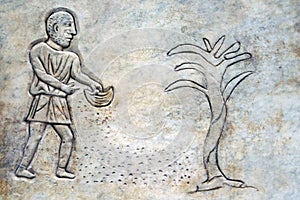 Bas-relief of an ancient Roman farmer throwing seeds on the ground
