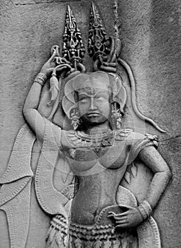 Bas-relief carving of ancient dancer at a ruined temple in Angkor Wat - Siem Reap, Cambodia